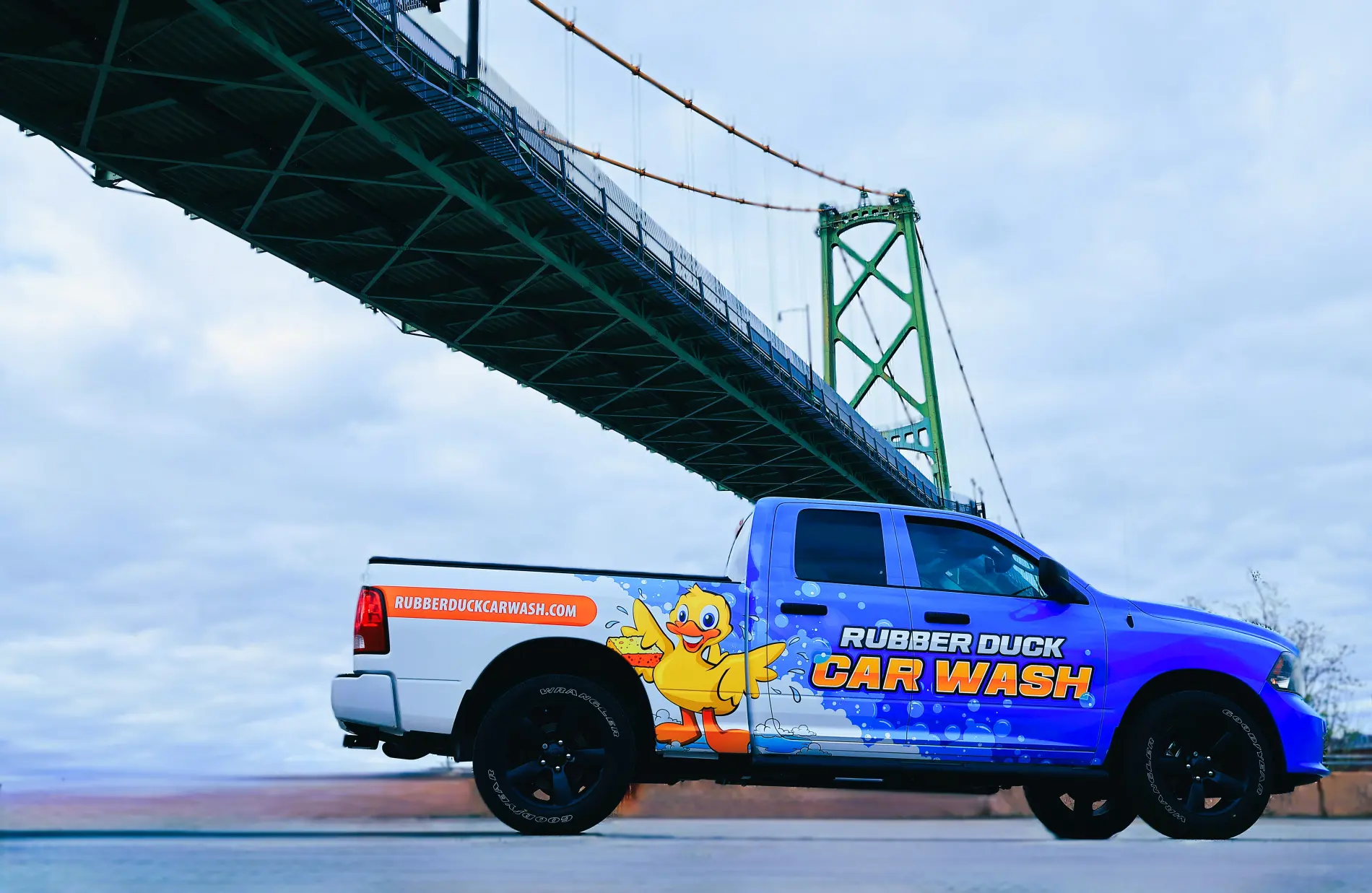 A branded Rubber Duck Car Wash truck parked under the Halifax bridge